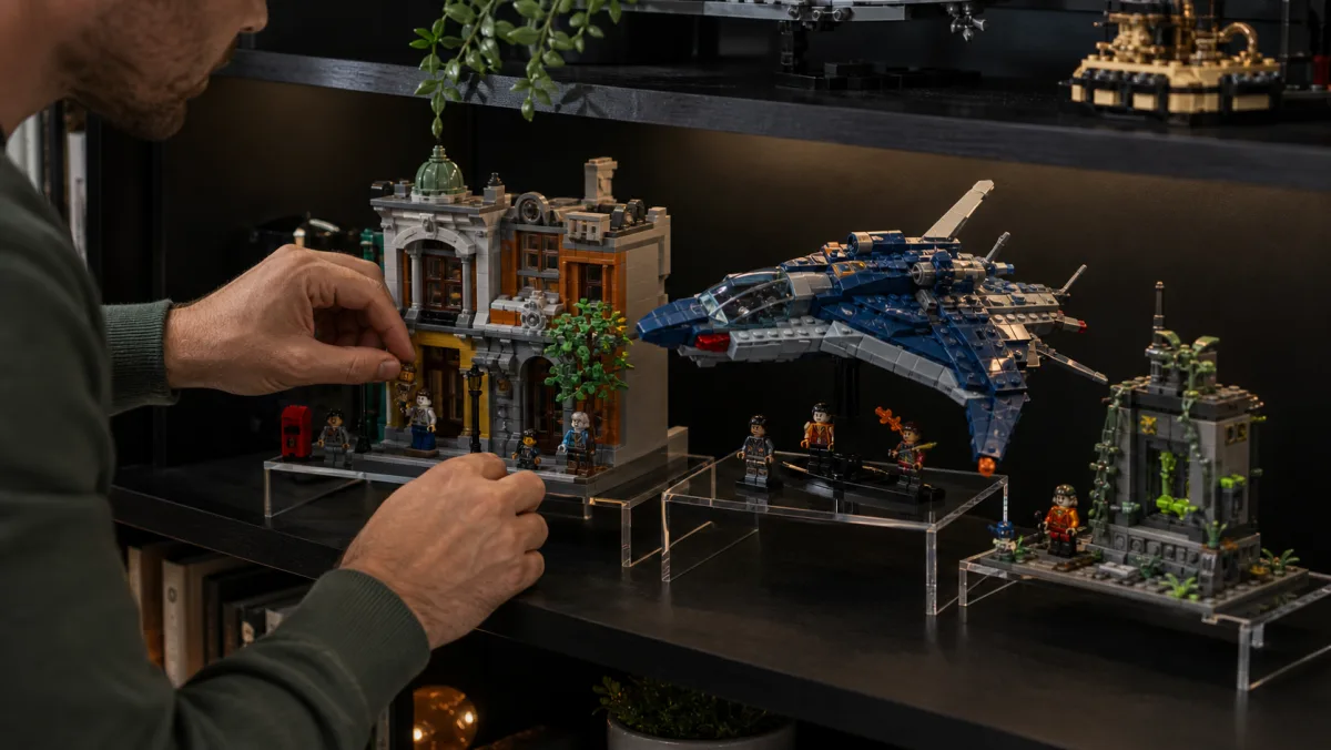 Brick-built action city display with glass tower, red vehicle, blue aircraft and mechanical display model